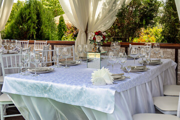 This image shows a beautifully set table for a formal event or a wedding reception