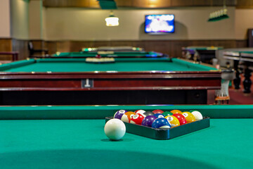 This is an image of a pool table with a rack of billiard balls on it