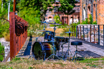 This is an image of a drum set placed outdoors likely in a park or a similar setting