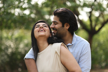 Fototapeta premium Joyful Couple Sharing A Laugh In A Park Setting