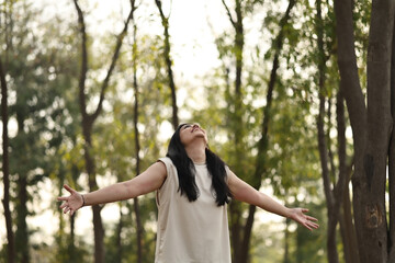 Woman Enjoying Nature With Arms Wide Open In Park