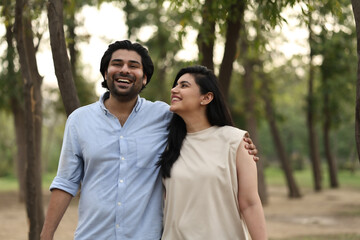 Couple Enjoying A Joyful Moment In A Park Setting