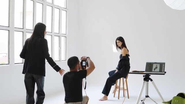 Fashion photoshoot in slow motion, model posing, photographer shooting, art director guiding