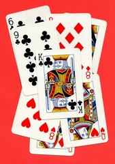 A montage of playing cards on a bright red background.