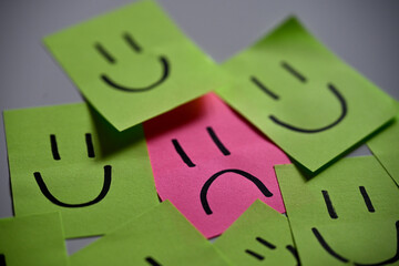 Stand Out From the Crowd – Sad Face Among Smiling Notes
Conceptual image representing...