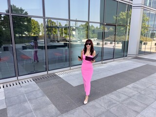 Modern businesswoman with sunglasses and documents