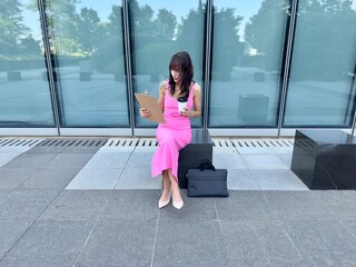 Businesswoman reviewing documents outdoors
