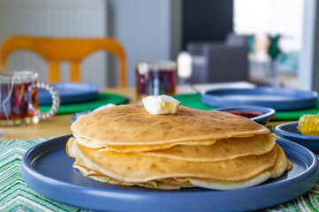 Homemade family breakfast with pancakes and honey on rustic table Description: Top view of a family...