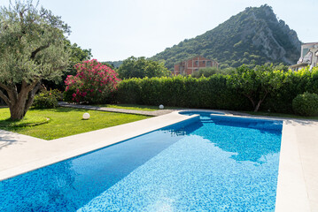 Outside outdoor pool with blue water in backyard of country house cottage