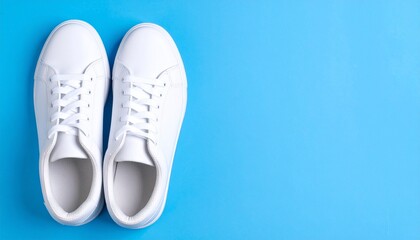 White sneakers with loose laces on bright blue background, positioned in upper left corner.