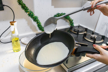 Pancakes are fried in a hot pan. Traditional homemade baking and cooking process.A series of home...