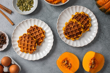 Autumn breakfast with pumpkin waffles and honey on a rustic table setting