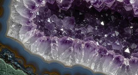 A captivating close-up captures the interior of an amethyst geode, showcasing the stunning purple crystals and the banded agate layers, evoking a sense of wonder and the beauty of natural formations.