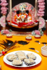 Traditional Indian Sweets Prasad in Front of Krishna Janmashtami Idol