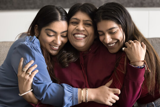 Family bonds. Thankful loving grownup daughters hugging happy smiling aged mom snuggle close from both sides to beloved parent share affectionate moment of pure love emotional connection appreciation