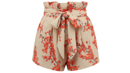 A stylish young woman poses gracefully in a beautiful short sleeved romper adorned with an intricate floral pattern and a charming bow tied at the waist set against a neutral backdrop.