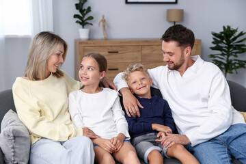 Happy family sitting on sofa at home