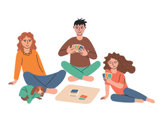 Friends sitting on the floor and playing exciting board games. Cards in their hands.