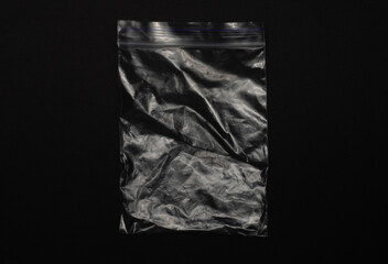 Transparent empty ziplock bag isolated on black background, clear plastic pouch with resealable...