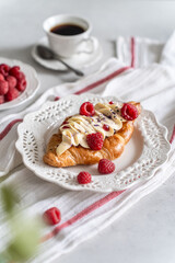 Trendy flat croissant on white plate, coffee. Delicious buttery thin croissant with fresh...
