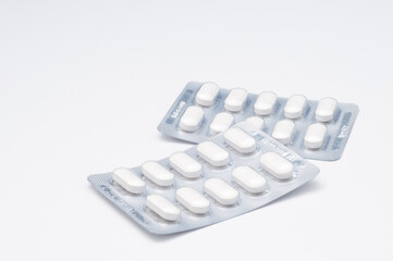 Two pills blister pack on white background, Medical concept, healthcare, pharmacy, medication, and...