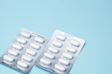 Two pills blister pack on blue background, Medical concept, healthcare, pharmacy, medication, and...