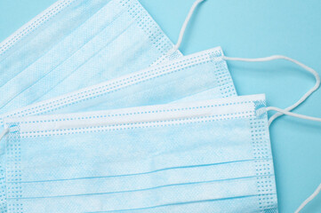Three blue medical mask, top view on blue background, healthcare, safety, and protective face mask...