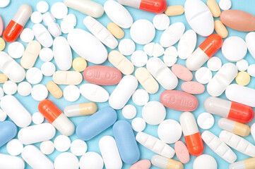 Various pills flat lay, top view on blue background, healthcare, medication, pharmacy, and medical concept