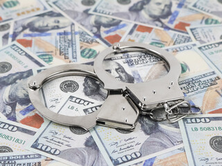 Shiny handcuffs with hundred-dollar bills