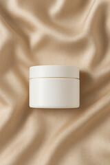 White Cosmetic Cream Jar on Luxurious Silky Fabric