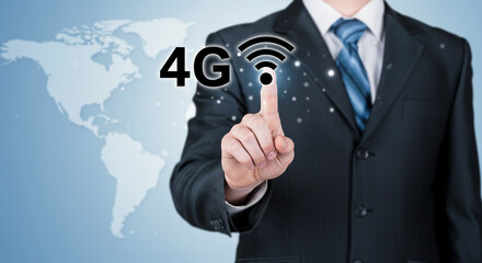 Businessman pointing at 4G wireless network icon with world map background representing mobile communication