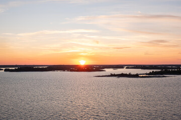Bright sunset over the sea, horizon, and islands on the horizon.