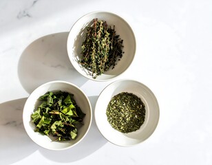 Three bowls of dried herbs and leafy greens.