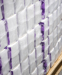 Close-up of white toilet paper, cellulose on a pallet in a warehouse