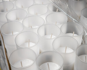 White paraffin candle inserts for the cemetery, many pieces close up