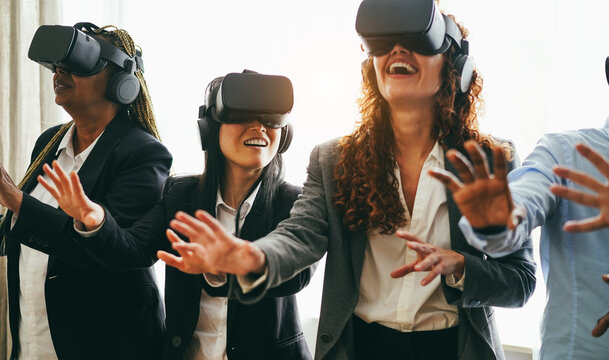 Business people wearing vr goggles inside office - New technology and ai concept - Main focus on left asian girl face