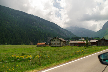 Winding mountain roads through Swiss alpine passes, offering dramatic views and an unforgettable...