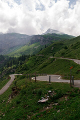 Winding mountain roads through Swiss alpine passes, offering dramatic views and an unforgettable...