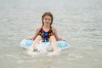 girl swimming on an inflatable ring