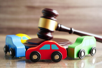 Car accident lawsuit and insurance, Judge hammer with car model.