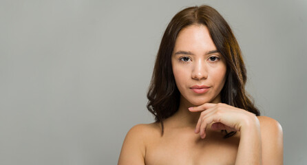 Portrait of a woman touching her face showing glowing skin