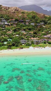 Vertical Drone Shot of Lanikai Beach, Popular Spot on Oahu Island, Hawaii USA, White Sand, Turquoise Ocean and Green Landscape