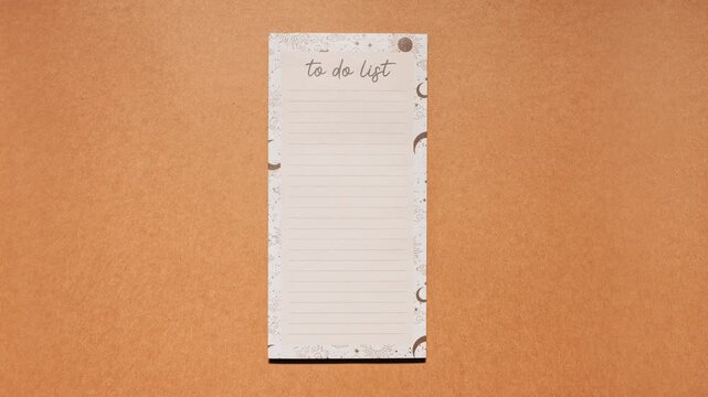 Stop motion of a lined to do list sheet sliding in and out on brown paper, loopable animation