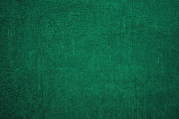 Fototapeta premium Dark green matte background, embossed textured wall.