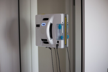 Robot window cleaner actively working on mirrow in modern interior space
