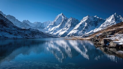 Fototapeta premium Mountain lake reflecting a snow-capped peak
