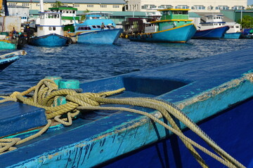 A close-up of a blue fishing boat with ropes at the Tsunami Binaa Maizaan in Malé in the Maldives