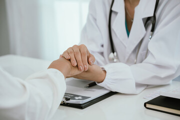 A doctor consults with a patient in a healthcare office, reviewing documents and providing medical advice, diagnosis, and treatment during a professional hospital or clinic appointment.
