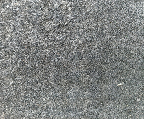 Close-up of gray felt fabric texture, soft material background for design or textile industry.