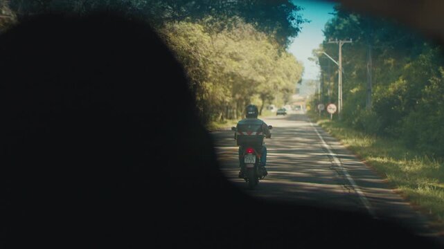 Person sits in the car moving on a road